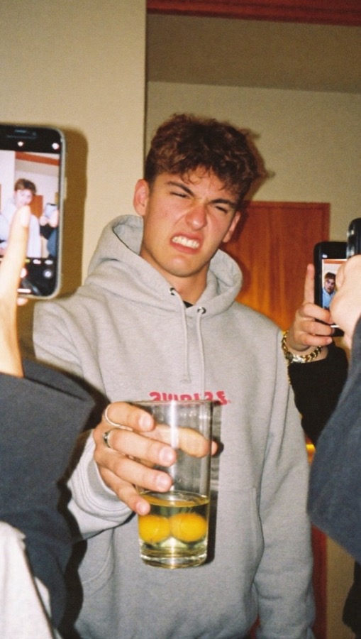 A friend about to drink three raw eggs while the group films
